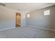Spacious carpeted bedroom with two smaller windows and a walk-in shower at 31985 N 117Th Ave, Peoria, AZ 85383