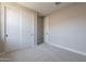 Neutral bedroom with closet, carpet floors, and a door at 31985 N 117Th Ave, Peoria, AZ 85383