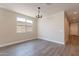 Light-filled dining area featuring hard floors, modern light fixture, and views of the backyard at 31985 N 117Th Ave, Peoria, AZ 85383