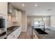 Modern kitchen featuring stainless steel appliances, granite countertops, and backsplash tiles at 31985 N 117Th Ave, Peoria, AZ 85383