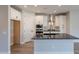 Contemporary kitchen featuring white cabinets, granite counters, stainless steel appliances, and modern fixtures at 31985 N 117Th Ave, Peoria, AZ 85383