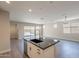 Bright kitchen with granite island, stainless steel appliances, and sliding glass doors to outdoor patio at 31985 N 117Th Ave, Peoria, AZ 85383