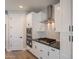 A well-equipped kitchen is showcased with stainless steel appliances, white cabinetry, and tiled backsplash at 31985 N 117Th Ave, Peoria, AZ 85383