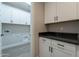 Functional laundry room with cabinets, counterspace, and hookups for washer and dryer at 31985 N 117Th Ave, Peoria, AZ 85383