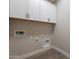 Clean laundry room with overhead cabinets, modern connections, and laminate flooring at 31985 N 117Th Ave, Peoria, AZ 85383