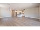 Spacious open-concept living room featuring hard floors and modern lighting fixtures, ideal for entertaining guests at 31985 N 117Th Ave, Peoria, AZ 85383