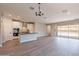 Spacious living area with gray floors and abundant natural light, seamlessly connecting to the modern kitchen at 31985 N 117Th Ave, Peoria, AZ 85383