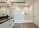 Modern bathroom with double sinks, white marble shower, and sleek black hardware at 32018 N 117Th Ave, Peoria, AZ 85383