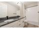 Well-lit bathroom featuring double sinks, granite countertops, and a shower-tub combination at 32018 N 117Th Ave, Peoria, AZ 85383