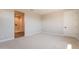 Neutral bedroom with plush carpet, ample natural light, and an ensuite bathroom at 32018 N 117Th Ave, Peoria, AZ 85383