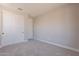 Neutral bedroom featuring plush carpeting, a double door closet, and a single door at 32018 N 117Th Ave, Peoria, AZ 85383