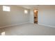 Bright bedroom with neutral carpeting, two windows for ample light, and a view into an adjoining bathroom at 32018 N 117Th Ave, Peoria, AZ 85383