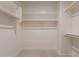 Walk-in closet with multiple shelves and bars for ample storage, with neutral carpeting at 32018 N 117Th Ave, Peoria, AZ 85383