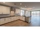 Modern kitchen with white cabinetry, stainless steel appliances, and an island with a breakfast bar at 32018 N 117Th Ave, Peoria, AZ 85383
