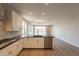 Open-concept kitchen with stainless appliances, granite countertops, and hardwood floors at 32018 N 117Th Ave, Peoria, AZ 85383
