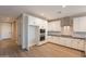 Spacious kitchen with stainless appliances, granite countertops, white cabinets, and hardwood floors at 32018 N 117Th Ave, Peoria, AZ 85383