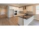 Bright modern kitchen featuring stainless appliances, granite countertops, and hardwood floors at 32018 N 117Th Ave, Peoria, AZ 85383