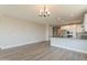 Open-concept living and kitchen space with hardwood floors and plenty of natural light at 32018 N 117Th Ave, Peoria, AZ 85383