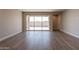 Bright living room featuring wood flooring and sliding glass doors leading to the outdoor space at 32018 N 117Th Ave, Peoria, AZ 85383