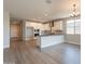 Open-concept living and kitchen space with hardwood floors, granite countertops, and modern fixtures at 32018 N 117Th Ave, Peoria, AZ 85383