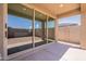 Covered patio with concrete flooring and large sliding glass doors offering seamless indoor-outdoor living at 32018 N 117Th Ave, Peoria, AZ 85383