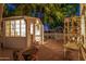 Quaint craft shed, surrounded by garden decor and a charming white picket fence at 1201 W Washington Ave, Gilbert, AZ 85233