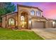 Charming two-story home with a well-manicured lawn, archway and a three car garage at 1201 W Washington Ave, Gilbert, AZ 85233