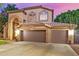 Charming two-story home showcasing a three car garage and desert landscaping at 1201 W Washington Ave, Gilbert, AZ 85233