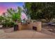 Built-in outdoor kitchen with barbecue grill, set in a landscaped backyard at 1201 W Washington Ave, Gilbert, AZ 85233