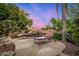 Relaxing poolside lounge area with comfortable seating and mature landscaping at 1201 W Washington Ave, Gilbert, AZ 85233