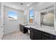 Modern bathroom featuring double sinks, ample counter space and mirrors and large window at 1329 W Via De Olivos Dr, San Tan Valley, AZ 85140