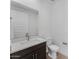 Stylish bathroom with dark wood vanity, white countertop, and modern fixtures throughout at 1329 W Via De Olivos Dr, San Tan Valley, AZ 85140