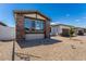 Charming home exterior features a combination of stone and stucco accents and low maintenance gravel landscaping at 1329 W Via De Olivos Dr, San Tan Valley, AZ 85140