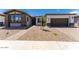 Charming single-story home with a gravel yard, brick accents, and a well-manicured lawn at 1329 W Via De Olivos Dr, San Tan Valley, AZ 85140