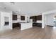 Stylish kitchen showcasing dark cabinetry, stainless steel appliances, and a functional center island at 1329 W Via De Olivos Dr, San Tan Valley, AZ 85140