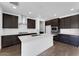 Modern kitchen featuring dark cabinets, a large island, stainless steel appliances, and subway tile backsplash at 1329 W Via De Olivos Dr, San Tan Valley, AZ 85140
