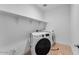 Bright laundry room featuring shelving, modern washer and dryer units, and light tile flooring at 1329 W Via De Olivos Dr, San Tan Valley, AZ 85140