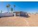 Expansive backyard featuring a covered patio, block wall, and desert landscape at 7508 W Osborn Rd, Phoenix, AZ 85033