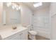 Bright bathroom with a vanity, toilet, and shower-tub combination with skylight at 7508 W Osborn Rd, Phoenix, AZ 85033