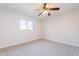 Bright bedroom with a ceiling fan and window that allows natural light at 7508 W Osborn Rd, Phoenix, AZ 85033
