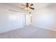 Bedroom featuring neutral carpet, closet and entry door to the hall at 7508 W Osborn Rd, Phoenix, AZ 85033