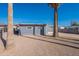 Exterior view of a blue home featuring a desert landscaped yard with palm trees at 7508 W Osborn Rd, Phoenix, AZ 85033