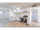 Updated kitchen featuring white cabinets, stainless steel appliances, and wood-look flooring at 7508 W Osborn Rd, Phoenix, AZ 85033
