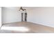 Spacious living room featuring light wood floors, neutral walls and a view into the kitchen at 7508 W Osborn Rd, Phoenix, AZ 85033