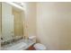 Bathroom with granite countertop, decorative mirror, framed glass shower, and neutral colors at 695 W Estrella Dr, Gilbert, AZ 85233