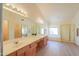 Well-lit bathroom with double vanity, soaking tub, separate shower, and lots of natural light at 695 W Estrella Dr, Gilbert, AZ 85233