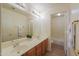 Bright bathroom with double sinks, large mirror, vanity lights and neutral walls at 695 W Estrella Dr, Gilbert, AZ 85233