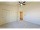 Bright bedroom with sliding door closet, carpeted floor, neutral walls, and an entry door at 695 W Estrella Dr, Gilbert, AZ 85233