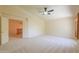 Bright bedroom with vaulted ceiling, plush carpet, large doorway, neutral walls, and ceiling fan at 695 W Estrella Dr, Gilbert, AZ 85233