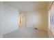 Neutral bedroom with carpeted floor, bright window and an entry door to another room at 695 W Estrella Dr, Gilbert, AZ 85233